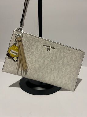 Michael Kors Cream Signature Wristlet with Tassel Charm